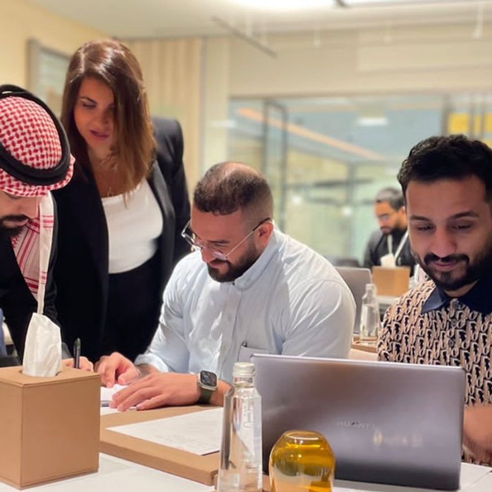 Hiba coaching participants at their table