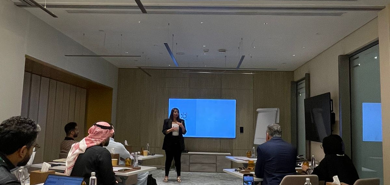 Hiba leading a workshop session for a leadership team